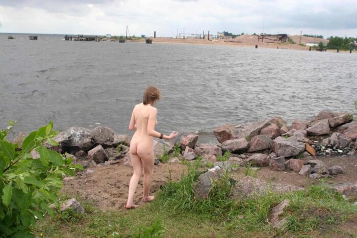 Blonde gets naked on the seashore