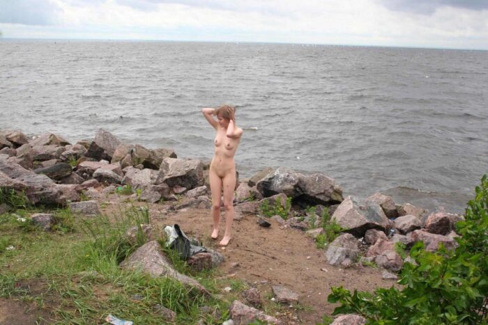 Blonde gets naked on the seashore
