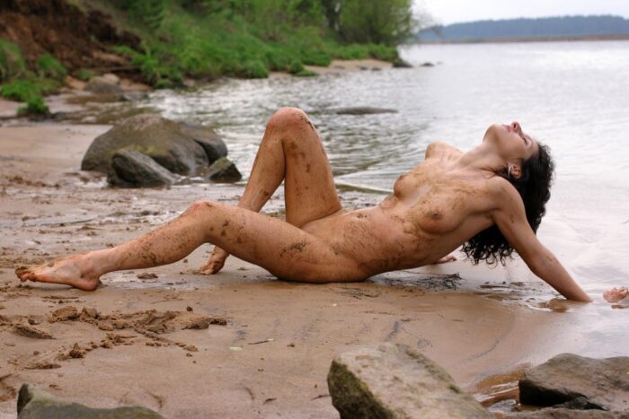 Curly brunette Gajana posing in dirt