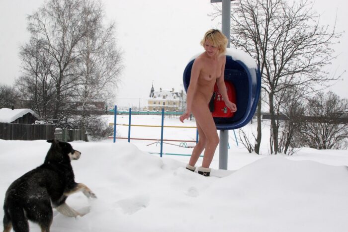 Naked blonde Diana talking on a payphone at winter