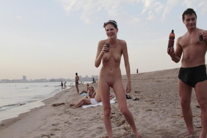 Naked brunette Mila S shows her pussy at public beach