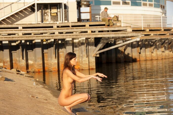 Russian girl Irina K without clothes by the city river