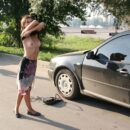 Young Vika D helps with a flat tire outdoors
