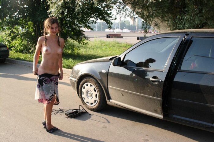 Young Vika D helps with a flat tire outdoors