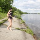 Beautiful girl fishing in the river without clothes with other fishermen