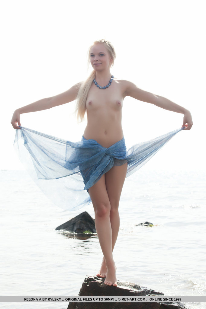 Feeona is a gorgeous sea nymph with a willowy physique. Her natural beauty stands out as poses naked against the azure sea and sky.