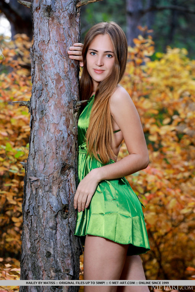 Hailey enchantingly takes off her green dress by the autumn colored bushes and reveal her bumtastic physique and smooth puffy punani.