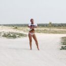 Russian girl Margarita S shows unshaven pussy on the sandy shore