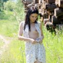 Small-tittied brunette Daria shows her pussy and ass outdoors