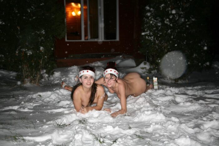 Two girls play in a snow after sauna