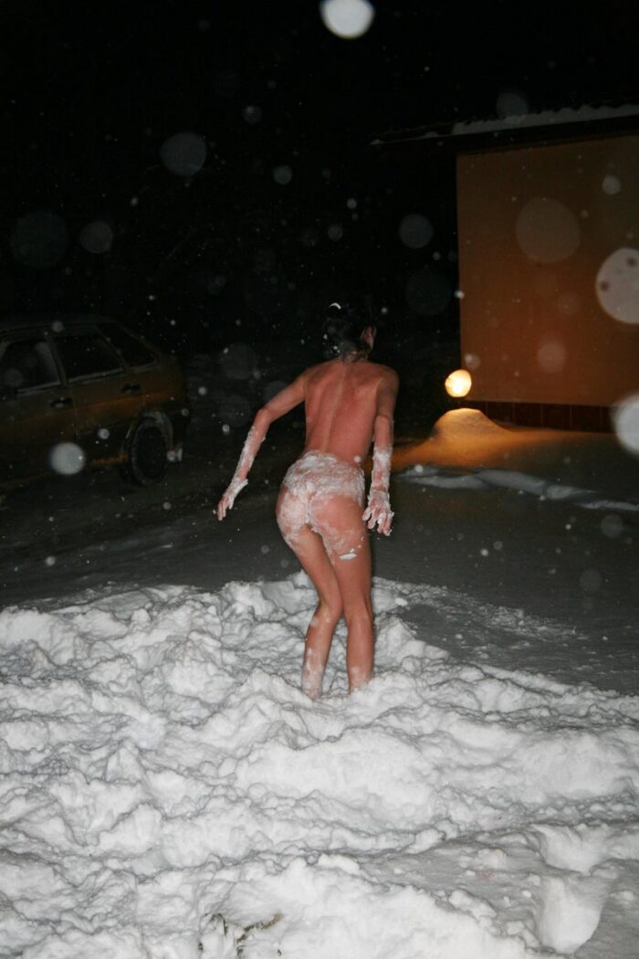 Two girls play in a snow after sauna