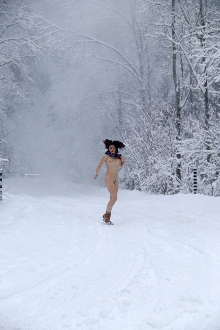 A girl without clothes is photographed during a blizzard