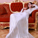 Alice Kelly glamorously strip out off her long gown and exposes her huge juicy melons and manicured pussy on the red elegant chair.