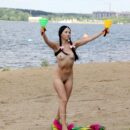 Hot russian brunette Veronica Snezna shows her shaved pussy at river beach