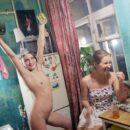 Naked girl Zhenja smokes in the kitchen with her friends