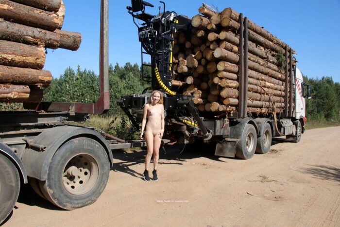 Naked teen blonde Isabel posing on timber carrier