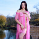Polly Pure exudes radiance in her pink sheer cover up by the calm waters of the lake. She takes it off and flashes her flawless skin and smooth pinkish kitty.