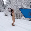 Russian girl Karolina plays with a snow outdoors