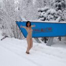 Russian girl Karolina plays with a snow outdoors
