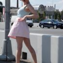 Smiling babe Masha removes pink panties to show her shaved pussy on the streets