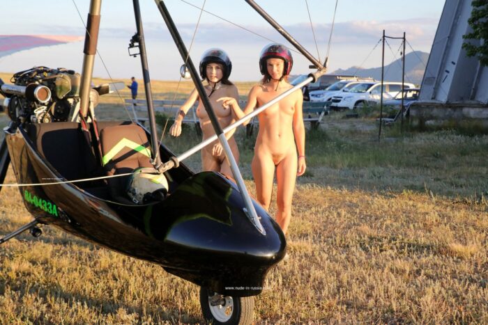 Two naked girls learn to fly on a gyroplane