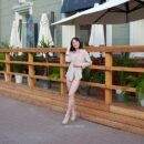 Brunette Nastja with cute tits walks naked at public street