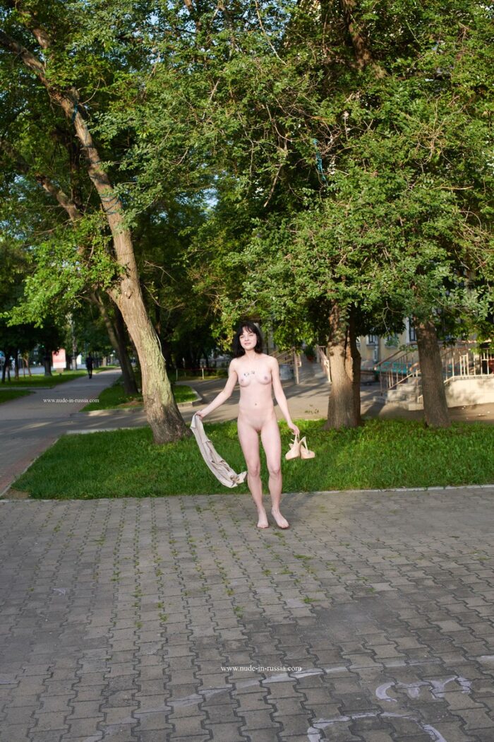 Brunette Nastja with cute tits walks naked at public street