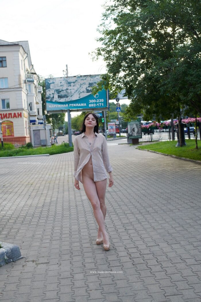 Brunette Nastja with cute tits walks naked at public street