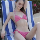 Leona Mia takes advantage of the sunny weather in her pink two-piece bikini which she eventually removes and flaunts her long slim physique and trimmed muff.