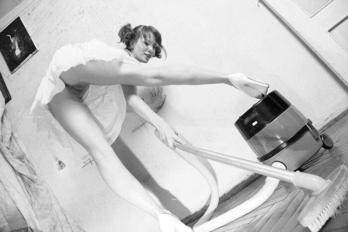 Lovely russian girl Masha posing with an old vacuum cleaner