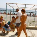 Naked Margarita S on a crowded embankment in a resort town