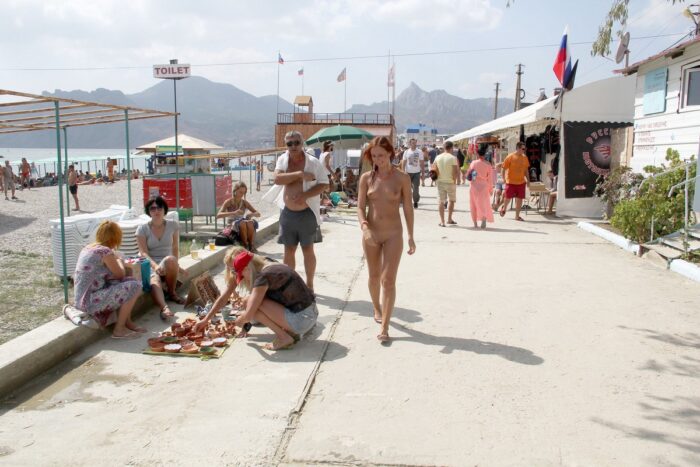 Naked Margarita S on a crowded embankment in a resort town