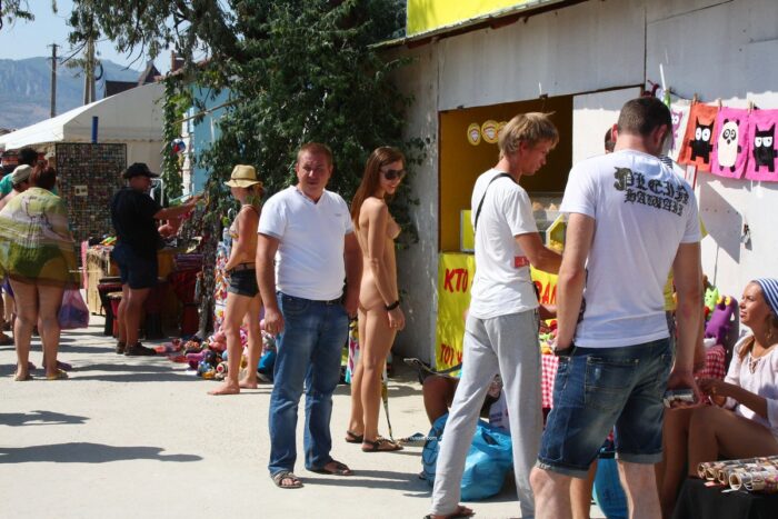 Russian girl Jana A undresses in a crowd of people