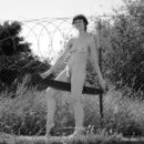 Russian mature woman with very hairy pussy posing with a saw outdoors