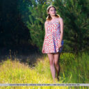 Dakota Pink is outdoors walking. She undress by the pine tree and flashes her huge juicy melons and smooth pinkish pussy.