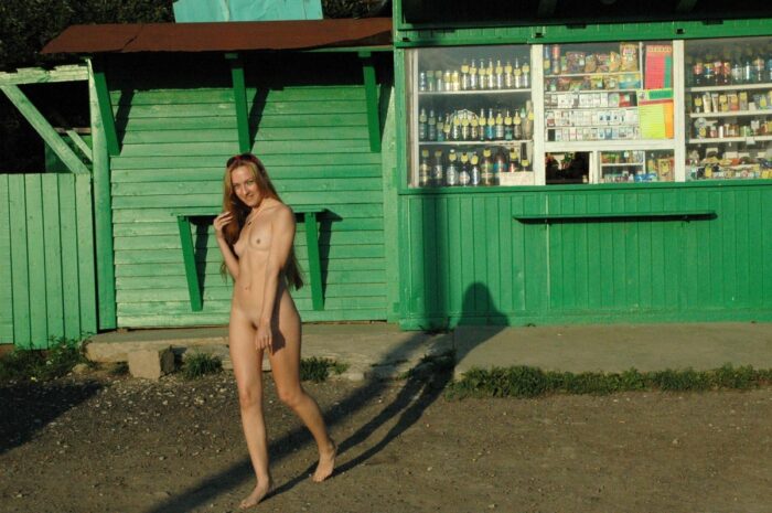 Fully naked blonde Asja poses at the kiosk