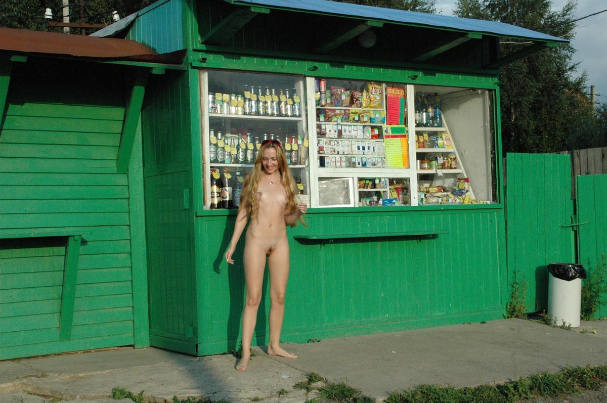 Fully naked blonde Asja poses at the kiosk — Russian Sexy Girls