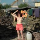 Girl Oxana D without clothes in sunglasses in the construction market