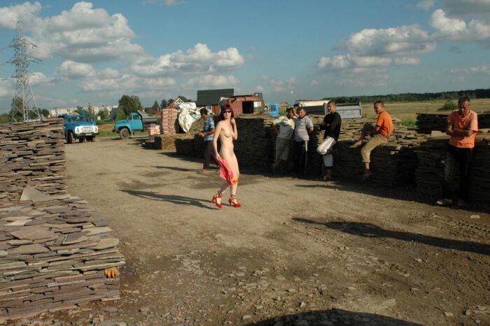 Girl Oxana D without clothes in sunglasses in the construction market
