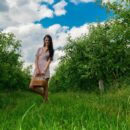 Katya enjoys an outdoor picnic in the orchard and a naughty outdoor masturbation.