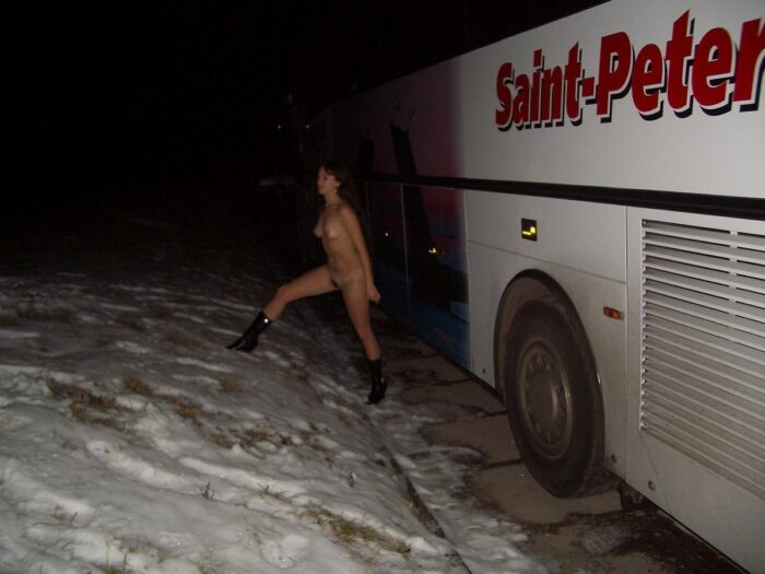 Russian girl Angelika posing at the tourist bus only in boots