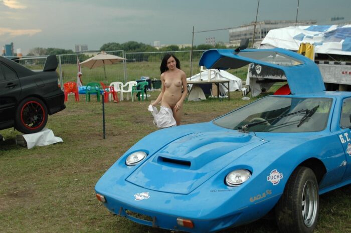 Young brunette with beautiful boobs at the old sports car