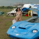 Young brunette with beautiful boobs at the old sports car