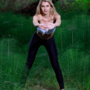 Christine Cardo shows off her flexibility as stretches her slim sexy body in the forest.