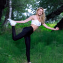 Christine Cardo shows off her flexibility as stretches her slim sexy body in the forest.