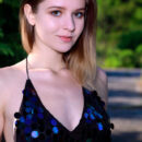 Libby is walking in the wilderness  in heels as she lifts the hem of her sexy sequined blue dress and show off her stiff knockers and shaved pinkish coochie.