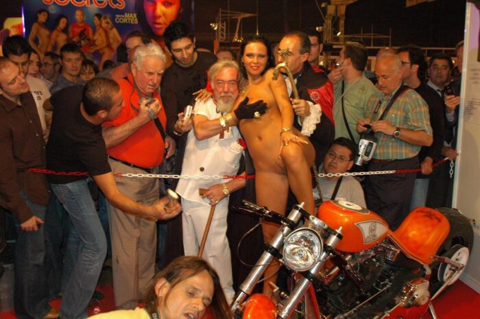Naked brunette Julia P on a motorcycle in front of the crowd of viewers