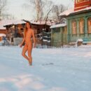 Slender blonde Sveta S with small tits walks through the snow in the village