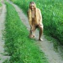 Smiling Russian blonde plays with vibrator outdoors