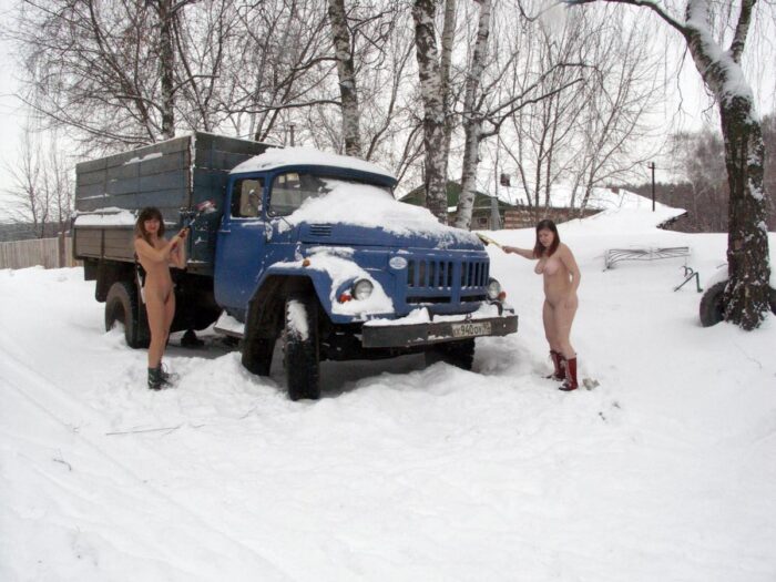 Two naked Russian girls clean the snow truck